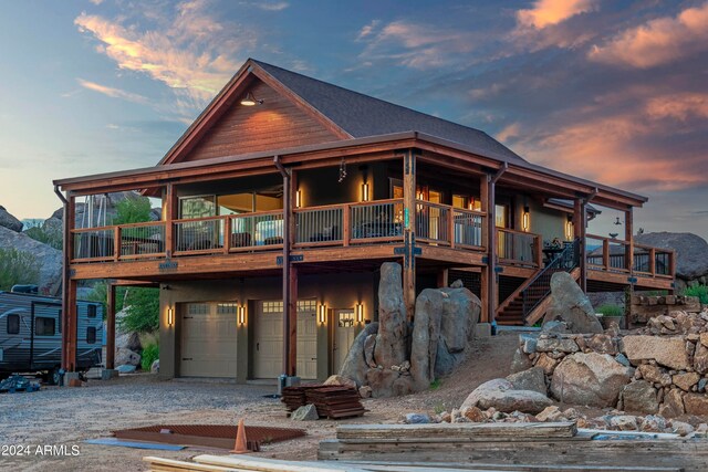 view of front facade with a garage and a deck