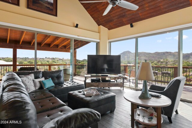 sunroom / solarium featuring ceiling fan, vaulted ceiling, and wooden ceiling