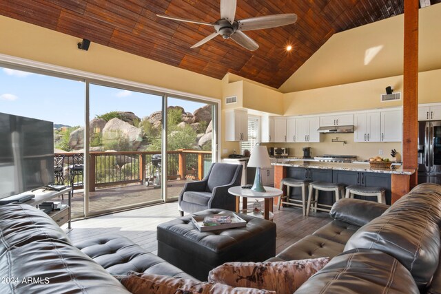 living room with wood-type flooring, high vaulted ceiling, a wealth of natural light, and wood ceiling