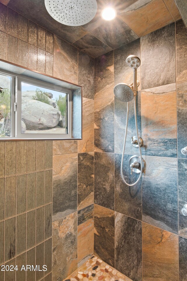 bathroom with tiled shower