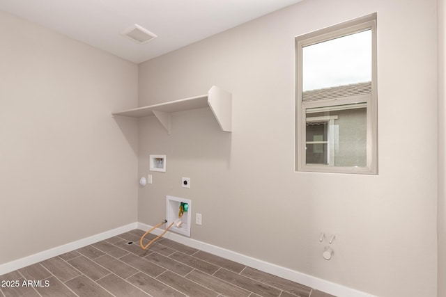 15599 S 180th Ln, Goodyear, AZ 85338 - laundry room featuring gas dryer hookup, hookup for an electric dryer, baseboards, hookup for a washing machine, and wood tiled floors