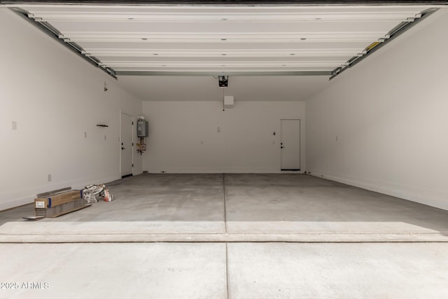 15599 S 180th Ln, Goodyear, AZ 85338 - garage featuring a garage door opener, baseboards, and water heater