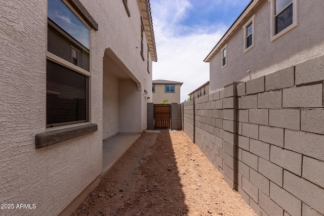 15599 S 180th Ln, Goodyear, AZ 85338 - view of side of home with a gate and stucco siding
