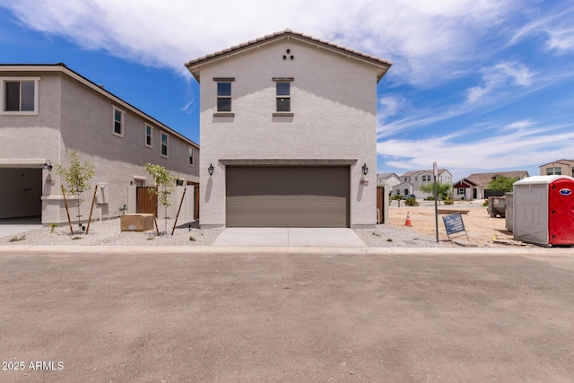 15599 S 180th Ln, Goodyear, AZ 85338 - view of front of home with stucco siding, an attached garage, and a residential view
