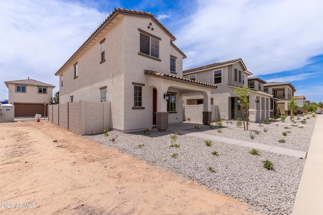 15599 S 180th Ln, Goodyear, AZ 85338 - mediterranean / spanish-style house featuring stucco siding, a tile roof, and an attached garage