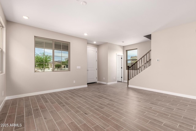 15599 S 180th Ln, Goodyear, AZ 85338 - unfurnished living room with plenty of natural light, baseboards, recessed lighting, stairway, and wood finished floors
