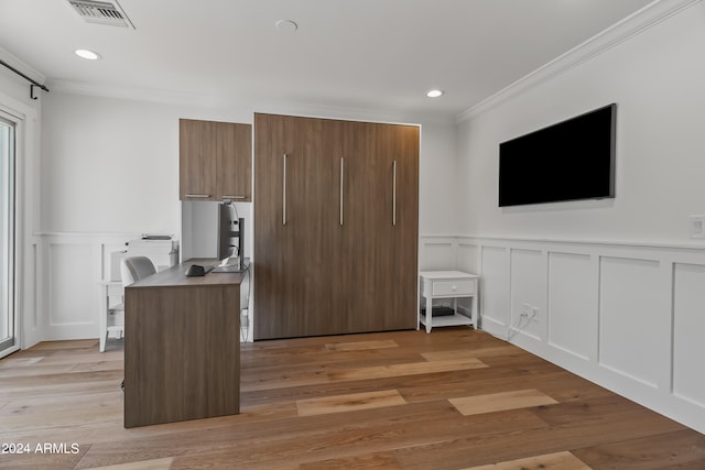 kitchen with light hardwood / wood-style flooring and ornamental molding