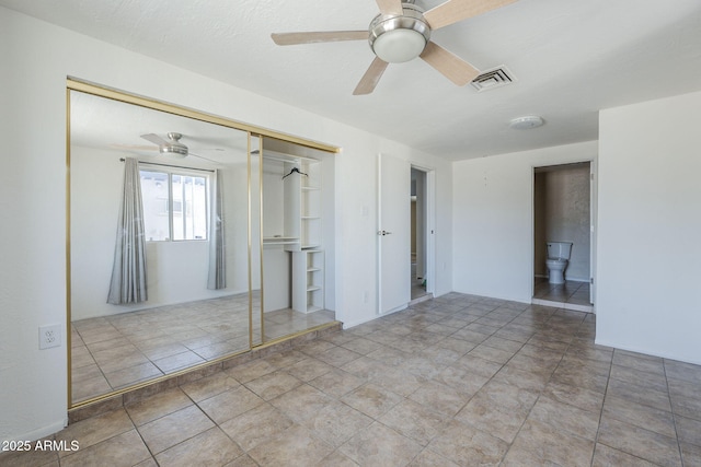 4025 E Surrey Ave, Phoenix, AZ 85032 - unfurnished bedroom with a closet, ceiling fan, and tile patterned flooring
