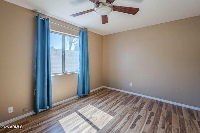 4025 E Surrey Ave, Phoenix, AZ 85032 - spare room with wood finished floors, baseboards, and ceiling fan