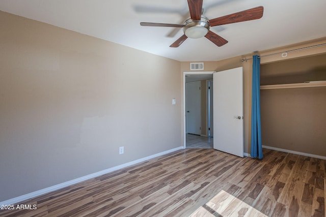 4025 E Surrey Ave, Phoenix, AZ 85032 - unfurnished bedroom with wood finished floors, a closet, baseboards, and ceiling fan