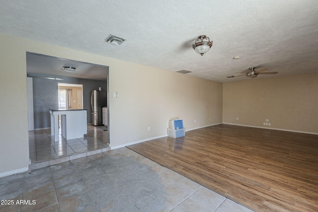 4025 E Surrey Ave, Phoenix, AZ 85032 - tiled empty room featuring ceiling fan, a textured ceiling, and baseboards