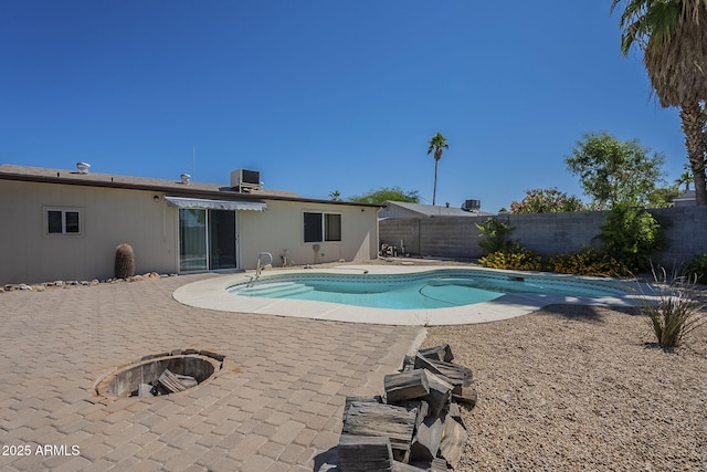 4025 E Surrey Ave, Phoenix, AZ 85032 - view of swimming pool with an outdoor fire pit, a fenced backyard, a patio, and central AC