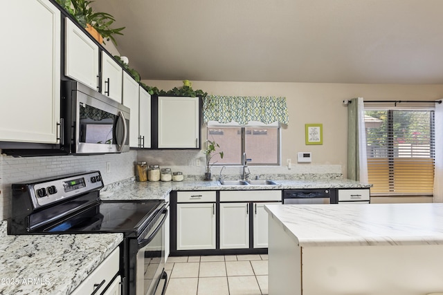 3534 N 106th Ln, Avondale, AZ 85392 - kitchen featuring stainless steel appliances, light tile patterned floors, backsplash, white cabinetry, and light stone counters