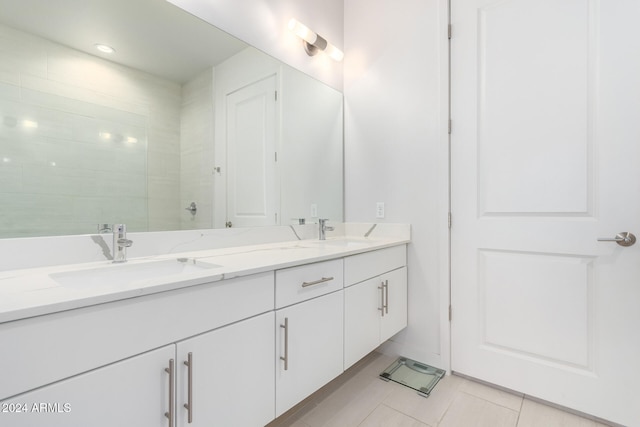 bathroom featuring vanity, tile patterned flooring, and tiled shower