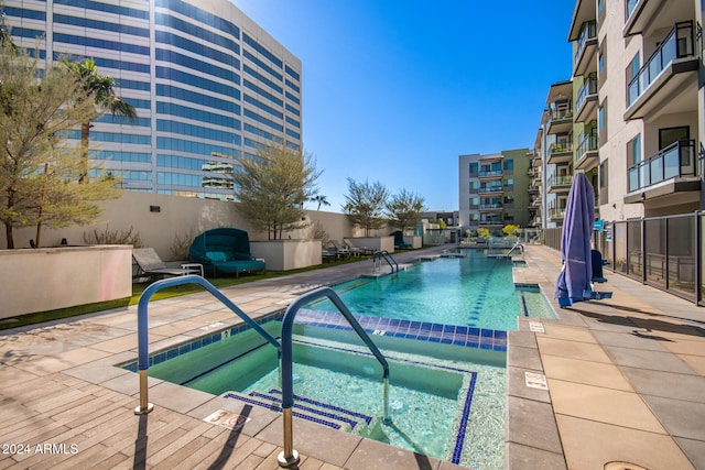 view of pool with a patio area and a community hot tub