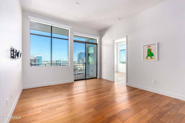 spare room with light wood-type flooring