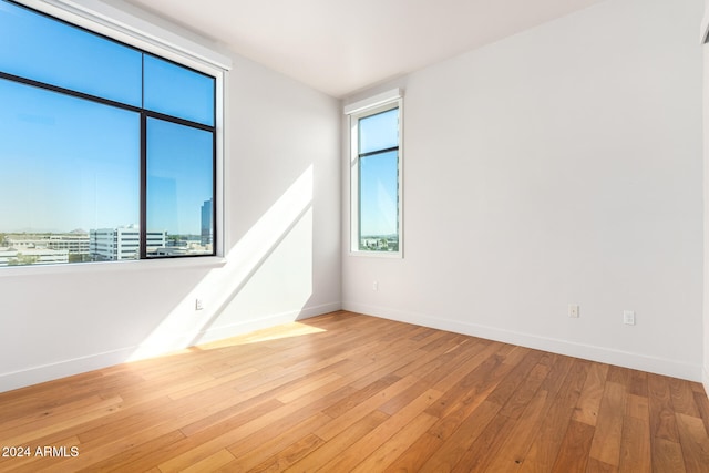 unfurnished room with hardwood / wood-style flooring