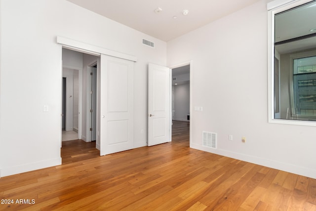 unfurnished bedroom with hardwood / wood-style floors