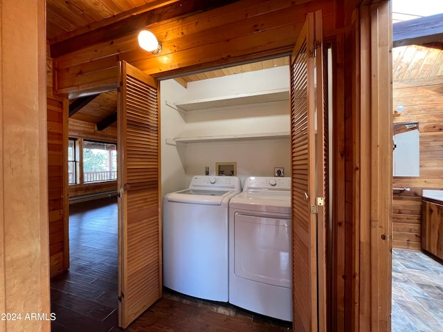 laundry room featuring wood ceiling, dark hardwood / wood-style flooring, wooden walls, and washer and clothes dryer