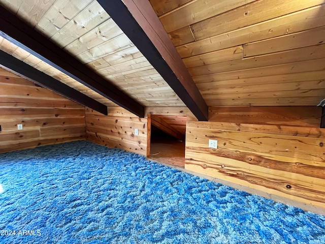 bonus room featuring lofted ceiling with beams, wooden walls, wooden ceiling, and carpet