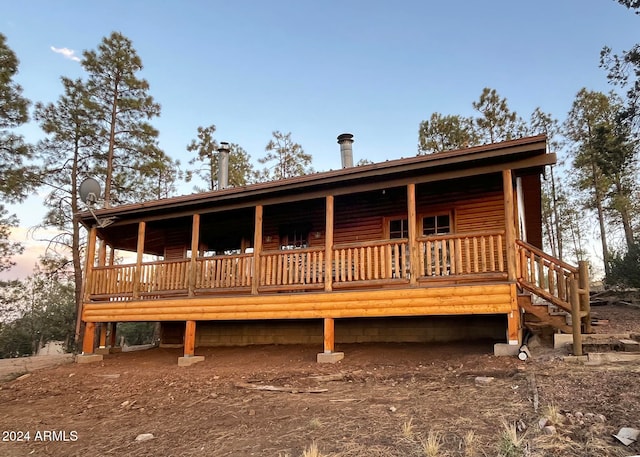 view of back house at dusk