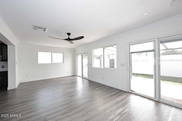 unfurnished living room featuring hardwood / wood-style flooring, ceiling fan, and ornamental molding