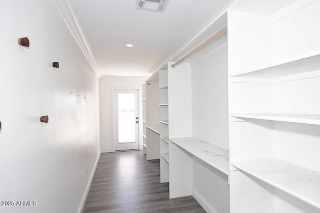 interior space featuring crown molding and dark wood-type flooring