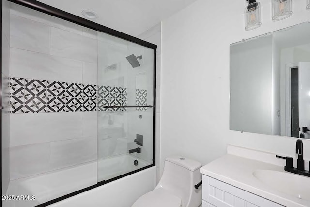 full bathroom with vanity, combined bath / shower with glass door, and toilet