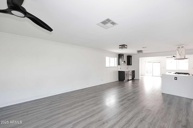 unfurnished living room featuring crown molding, hardwood / wood-style floors, and ceiling fan