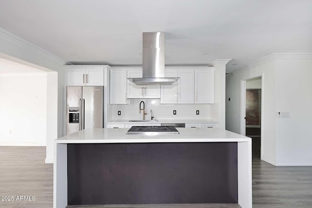 kitchen with white cabinetry, sink, island range hood, and appliances with stainless steel finishes