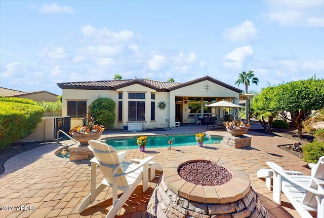 view of swimming pool featuring a patio area and an outdoor fire pit