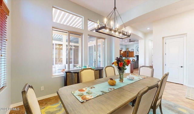 dining space featuring light tile patterned flooring, plenty of natural light, and an inviting chandelier