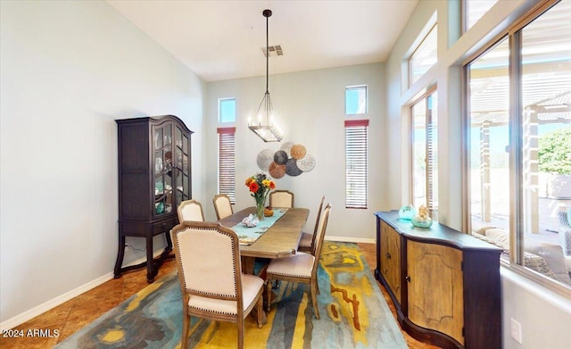 dining space featuring dark tile patterned floors