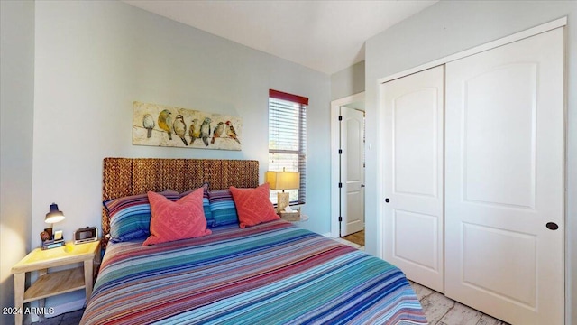 bedroom with light hardwood / wood-style flooring and a closet