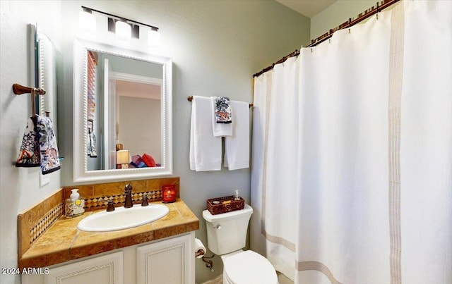 bathroom with toilet and vanity