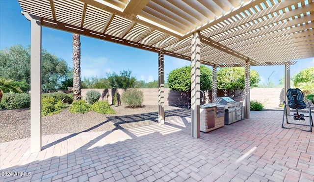 view of patio / terrace featuring area for grilling, an outdoor kitchen, and a pergola