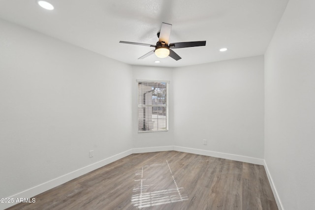 spare room with recessed lighting, wood finished floors, a ceiling fan, and baseboards