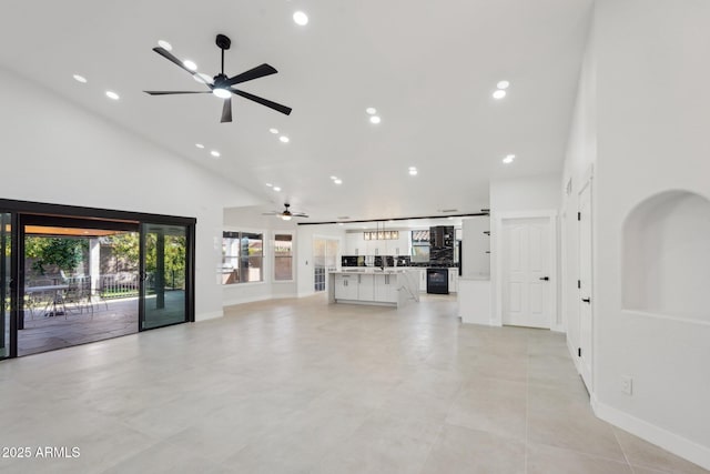 unfurnished living room with ceiling fan, high vaulted ceiling, and recessed lighting