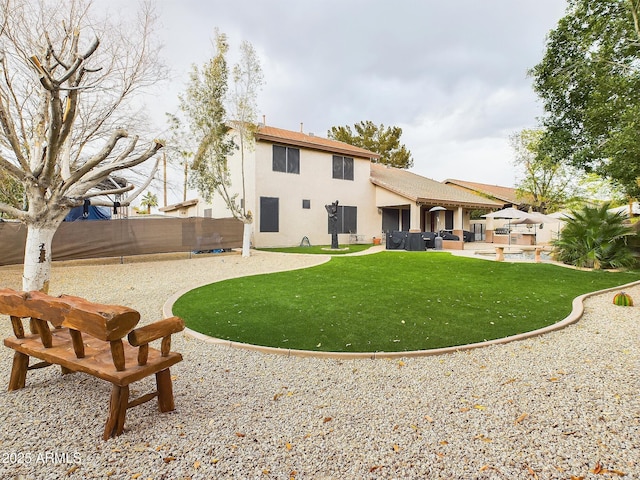 rear view of house featuring a yard, outdoor lounge area, and a patio