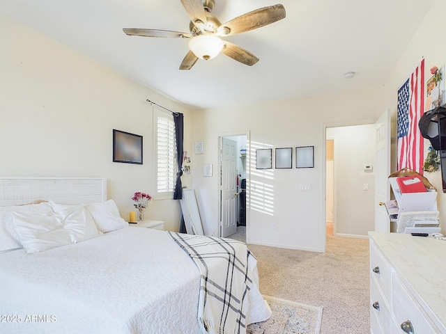 carpeted bedroom with ceiling fan and a spacious closet