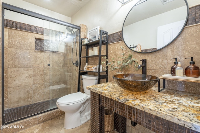 bathroom featuring sink, walk in shower, and toilet