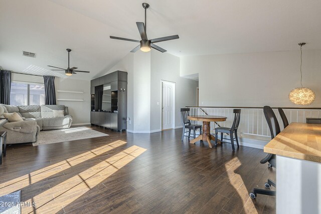 living room featuring ceiling fan, vaulted ceiling, and dark wood-type flooring