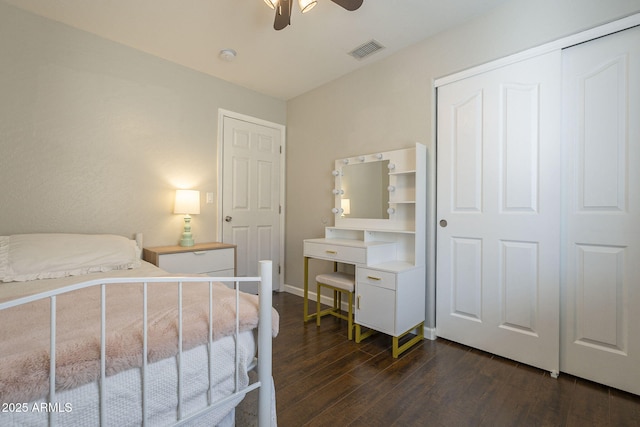 bedroom with a closet, ceiling fan, and dark hardwood / wood-style floors