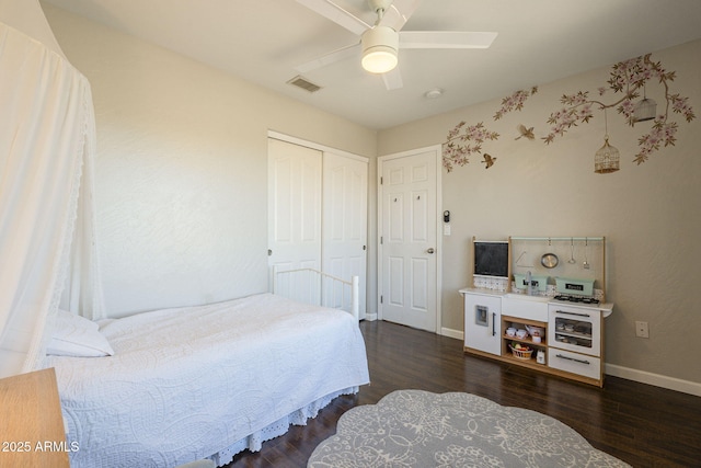 bedroom with a closet, ceiling fan, and dark hardwood / wood-style floors