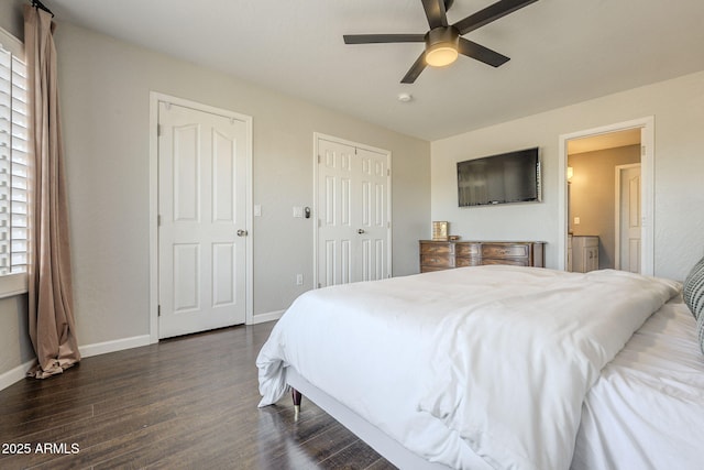 bedroom with dark wood-type flooring, ceiling fan, and multiple windows