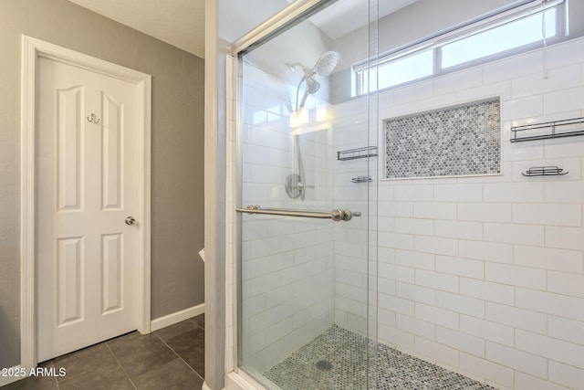 bathroom with tile patterned floors and a shower with shower door