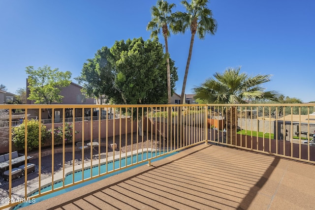 deck featuring a fenced in pool