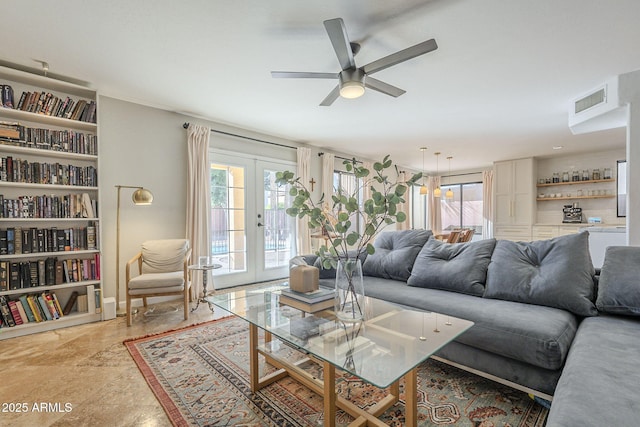 living room featuring ceiling fan and french doors