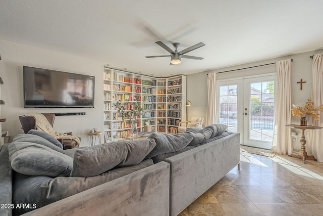 tiled living room with ceiling fan and french doors