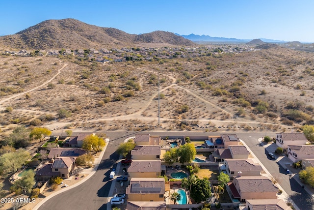 birds eye view of property with a mountain view